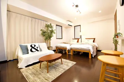 a room with two beds and a table at Kanbe Building 301 in Tokyo