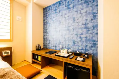 a desk in a room with a blue wall at KIN HOTEL in Tokyo