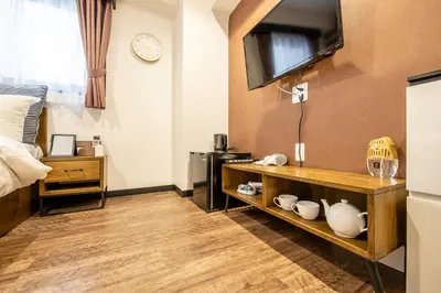 a room with a bed and a tv on the wall at The Park Hotel Akihabara in Tokyo
