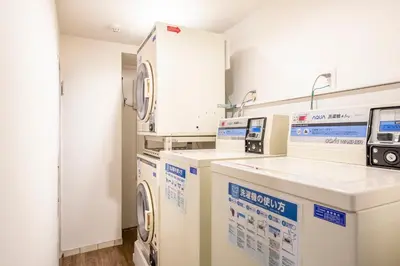 a laundry room with washers and dryers at The Park Hotel Akihabara in Tokyo