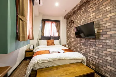 a bedroom with a brick wall and a bed at The Park Hotel Akihabara in Tokyo