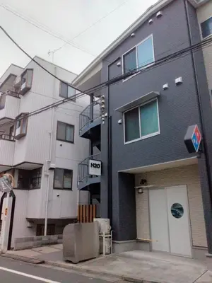 a building on a street next to a building at H2O Stay Ikebukuro in Tokyo