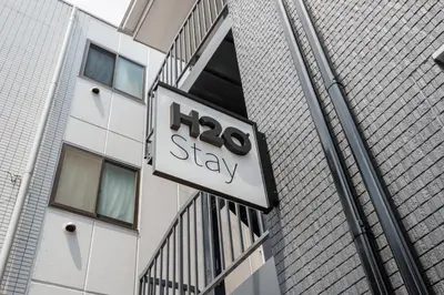 a sign on the side of a building at H2O Stay Ikebukuro in Tokyo