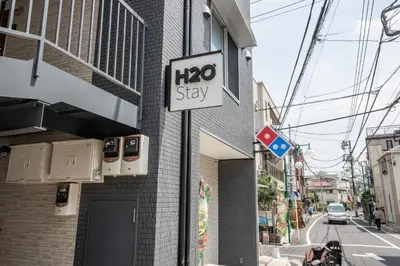 a sign on the side of a building at H2O Stay Ikebukuro in Tokyo