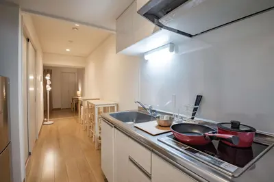 a kitchen with two pots and pans on a stove at H2O Stay Ikebukuro in Tokyo