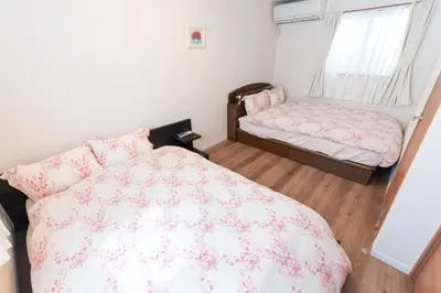 a small bedroom with a bed and a window at Mori House In \u897f\u65e5\u66ae\u91ccI in Tokyo