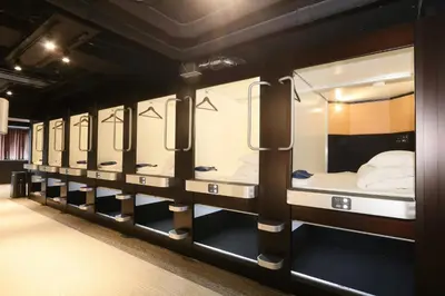 a row of bunk beds in a room at Capsule Room Lightning Hotel Asakusa in Tokyo
