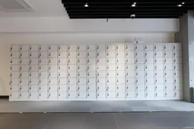 a wall with a bunch of doors in a room at Capsule Room Lightning Hotel Asakusa in Tokyo