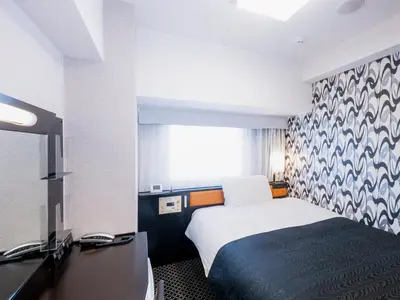 a hotel room with a bed and a tv at APA Hotel Yamanote Otsuka Ekimae Tower in Tokyo