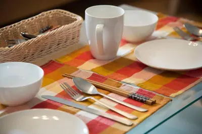 a table with plates and utensils on a colorful table cloth at Roppongi Azabu Gorgeous Sea House in Tokyo