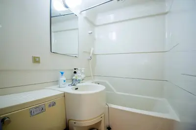 a bathroom with a sink and a tub and a mirror at Roppongi Azabu Gorgeous Sea House in Tokyo