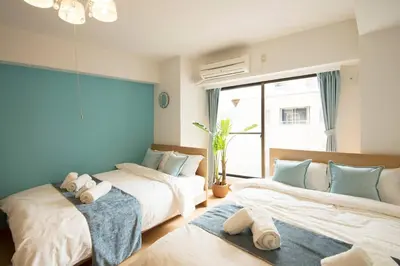 a bedroom with two beds and a window at Roppongi Azabu Gorgeous Sea House in Tokyo