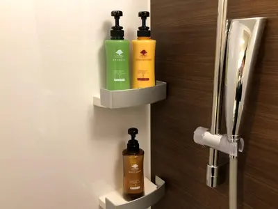 a bathroom with two bottles of soap on a wall at Ai Hotel Keikyu Kamata in Tokyo