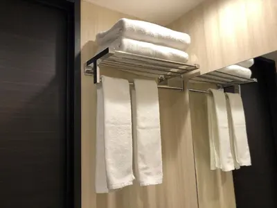 a bathroom with white towels on a towel rack at Ai Hotel Keikyu Kamata in Tokyo