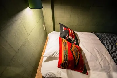 a bedroom with a bed with a pillow on it at IKIDANE Residential Hotel Komagome in Tokyo