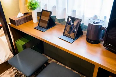 a wooden counter with three framed pictures on it at IKIDANE Residential Hotel Komagome in Tokyo