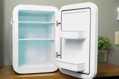 a white refrigerator sitting on top of a table at IKIDANE Residential Hotel Komagome in Tokyo