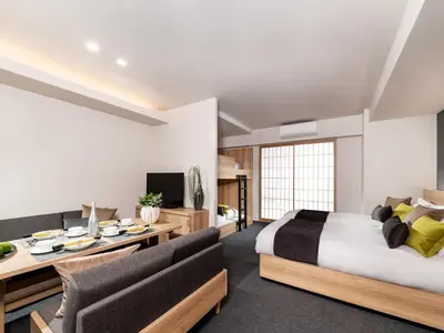 a bedroom with a bed and a desk and chairs at MIMARU Tokyo Ginza East in Tokyo