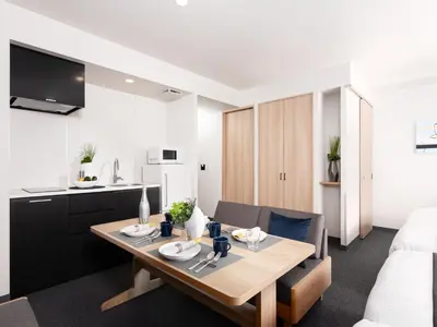 a kitchen and a living room with a table in a room at MIMARU Tokyo Ueno Okachimachi in Tokyo