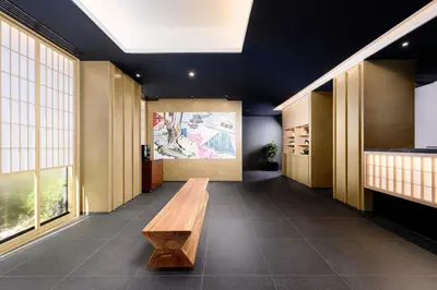 a hallway with a wooden bench in a building at MIMARU Tokyo Ueno Okachimachi in Tokyo