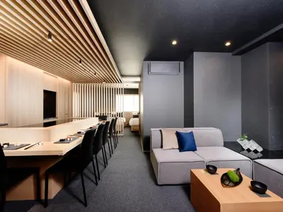 a living room with a couch and a table and chairs at MIMARU Tokyo Ueno Okachimachi in Tokyo