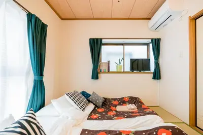 a bed in a room with a window at Bunkyo-ku Hakusan House in Tokyo