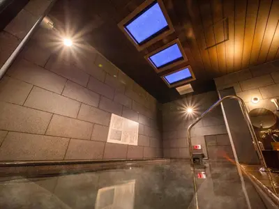 a bathroom with a bath tub with steam coming out of it at Super Hotel Premier Akihabara in Tokyo