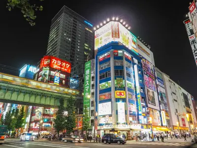 a busy city street at night with buildings at Super Hotel Premier Akihabara in Tokyo