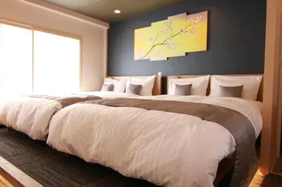 a bedroom with two beds with white sheets at Sakura Stay Yoga 301 in Tokyo