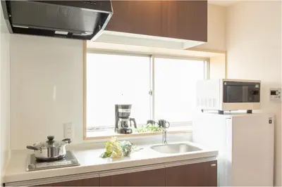 a kitchen with a sink and a white refrigerator at Sakura Stay Yoga 301 in Tokyo