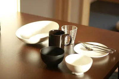 a wooden table with plates and utensils on it at Sakura Stay Yoga 301 in Tokyo