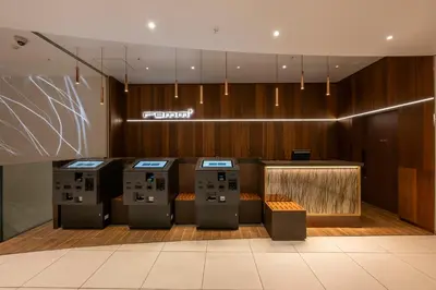 a lobby with four computer screens in a room at remm plus Ginza in Tokyo
