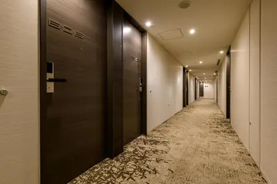 an empty corridor with a long corridor at remm plus Ginza in Tokyo
