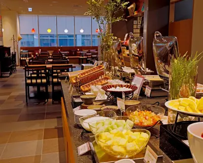 a buffet line with food on a table in a restaurant at remm plus Ginza in Tokyo