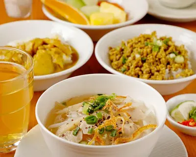 a table with bowls of food and a drink at remm plus Ginza in Tokyo