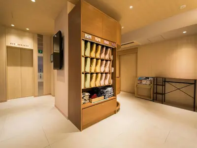 a walk in dressing room with a shoe rack at Super Hotel Tokyo Kinshicho Ekimae in Tokyo