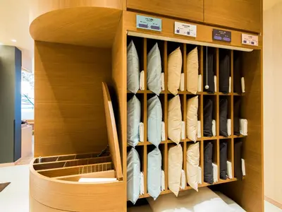 a closet with wooden shelving in a store at Super Hotel Tokyo Kinshicho Ekimae in Tokyo