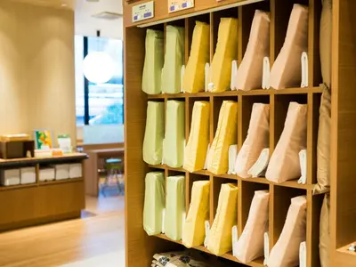 a wall of shoes in a store at Super Hotel Tokyo Kinshicho Ekimae in Tokyo