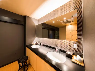 a bathroom with two sinks and a large mirror at Super Hotel Tokyo Kinshicho Ekimae in Tokyo