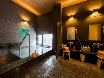 a bathroom with a tub and a sink and a toilet at Super Hotel Tokyo Kinshicho Ekimae in Tokyo