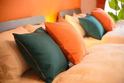 a group of pillows sitting on a bed at Roppongi Azabu Sunshine Resort House in Tokyo