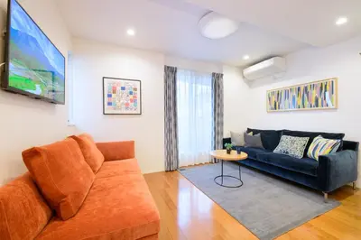 a living room with a couch and a table at Sangen-jaya House-O in Tokyo