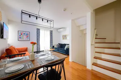a kitchen and living room with a table and chairs at Sangen-jaya House-O in Tokyo