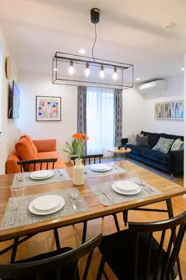 a dining room and living room with a table and chairs at Sangen-jaya House-O in Tokyo