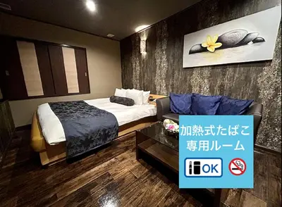 a hotel room with a bed and a couch at Hotel Asian Color (Adult Only) in Tokyo