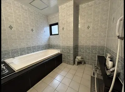 a bathroom with a bath tub and a window at Hotel Asian Color (Adult Only) in Tokyo