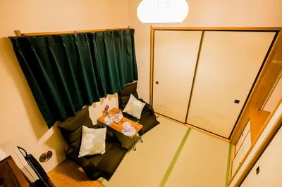 a room with a green curtain and a couch with pillows at Bunkyo-ku - Apartment / Vacation STAY 4147 in Tokyo