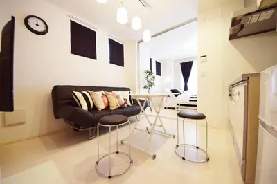 a living room with a couch and a table at Three Tokyo 101 in Tokyo