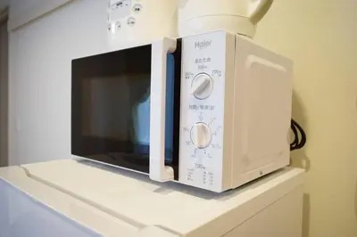 a microwave oven sitting on top of a counter at Three Tokyo 101 in Tokyo