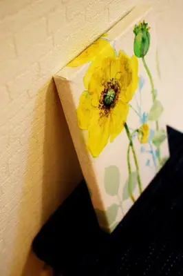 a vase with a yellow flower on a wall at Three Tokyo 102 in Tokyo